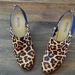 MK leopard print and black leather heels.